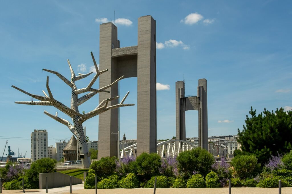 Accueil Contemporary bridge with artistic sculpture in Brest, France, under a clear blue sky.